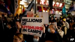 Demonstrators supporting Tibetans, Uyghurs and Hong Kongers take part in a protest against the Chinese Communist Party to coincide with the 72nd National Day of the People's Republic of China in London, Oct. 1, 2021. 