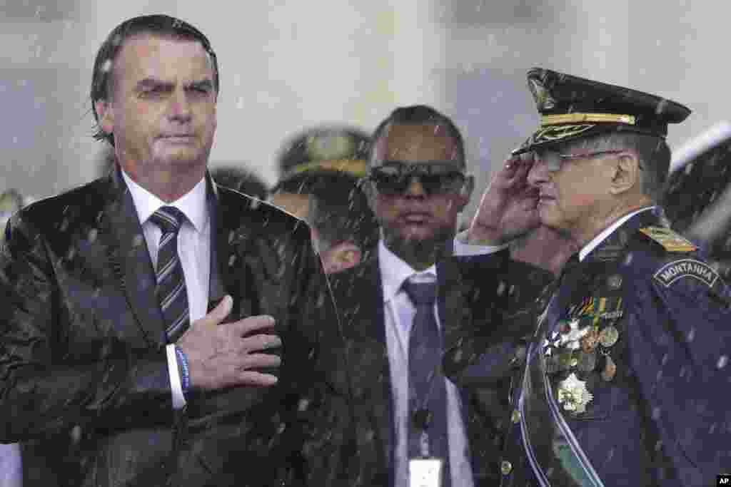 Brazil's President Jair Bolsonaro puts his hand over his heart while the national song plays in Brasilia, Brazil, on April 17, 2019. (AP Photo/Eraldo Peres)