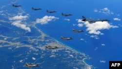 This handout photo taken Sept. 18, 2017 and provided by the South Korean Defense Ministry in Seoul shows U.S. and South Korean fighter jets flying over South Korea during a joint military drill aimed to counter North Korea’s latest nuclear and missile tes