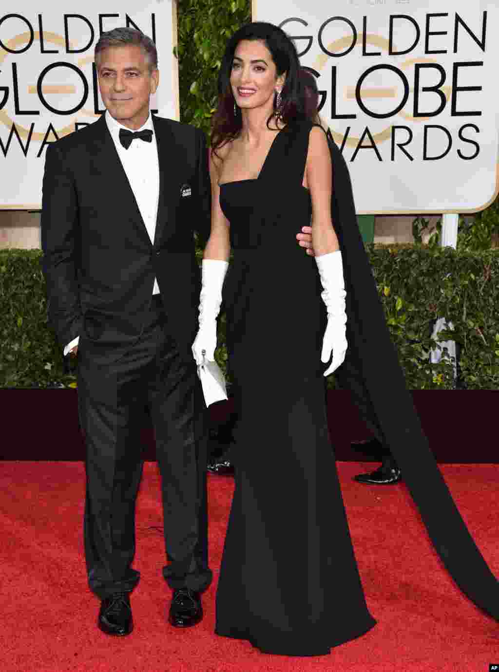George and Amal Clooney arrive at the 72nd annual Golden Globe Awards. George Clooney was honored with the Cecil B. DeMille Award for lifetime achievement, at the Beverly Hilton Hotel, in Beverly Hills, California, Jan. 11, 2015.