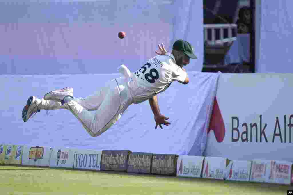 Pakistan's Sajid Khan attempts to take a catch of England's Jamie Smith on the boundary edge during a cricket match between Pakistan and England, in Rawalpindi, Pakistan.