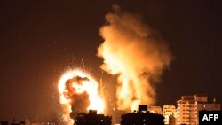 Fire rises from Israeli air strikes in the Gaza Strip, controlled by Hamas, on May 10, 2021. Israel launched the air strikes after a series of rockets fired by Hamas to answer the clashes in Jerusalem. (Photo by MAHMUD HAMS / AFP)