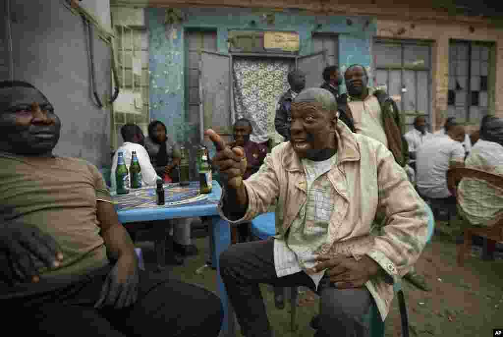 Nigerians in Kano, Nigeria have heated but friendly discussions about the delayed election, on February 16, 2019. (AP Photo/Ben Curtis)