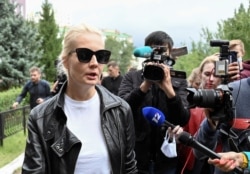 FILE - Yulia Navalnaya, wife of Russian opposition leader Alexei Navalny, speaks with the media outside a hospital, where Alexei receives medical treatment in Omsk, Russia, Aug. 21, 2020.