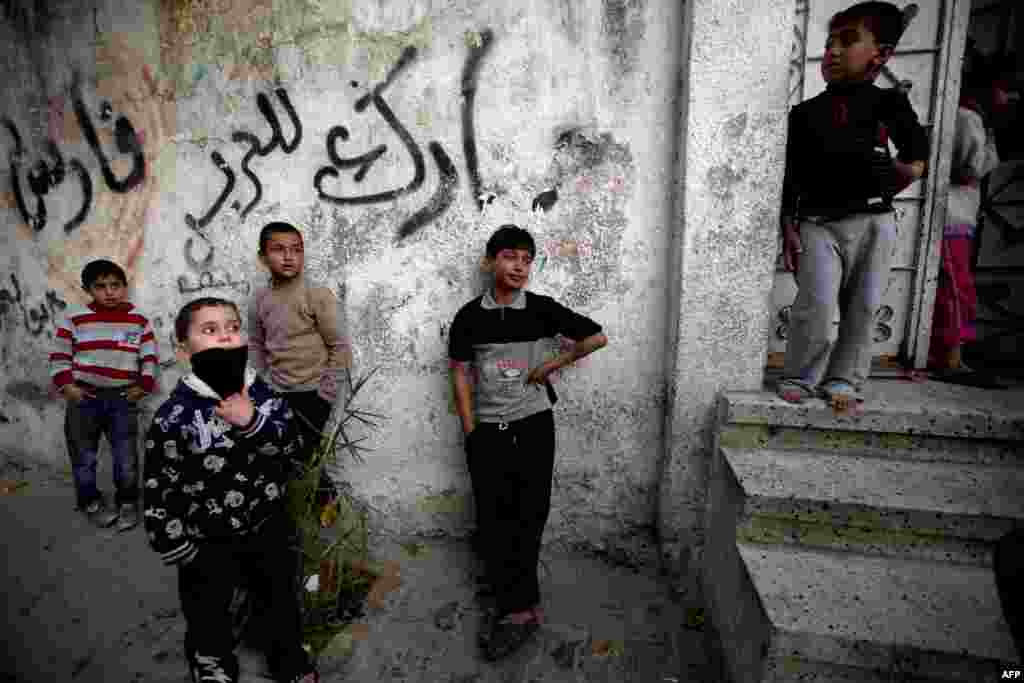 Young boys mourn during the funeral of Bilal Samir Oweida, a 20-year-old Palestinian, in Beit Lahia, northern Gaza Strip. Oweida was "shot in the chest by Israeli soldiers" east of Jabaliya according to a spokesman for the Hamas-run health ministry. Israeli forces said Oweida had entered "a prohibited area".