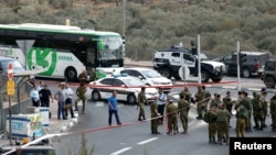 FILE - Israeli forces gather at an attempted stabbing near the Jewish settlement of Ariel in the occupied West Bank, Oct. 15, 2018. On Sunday in Ariel, a shooting left one dead and two wounded.
