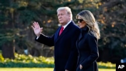 President Donald Trump and first lady Melania Trump walk to board Marine One on the South Lawn of the White House, Wednesday, Dec. 23, 2020, in Washington. (AP Photo/Evan Vucci)