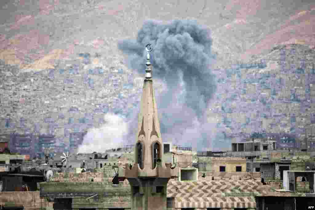 Smoke billows following a reported air strike in the rebel-held parts of the Jobar district, on the eastern outskirts of the Syrian capital Damascus.