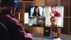 A user watches a video conference in this promotional image from Gumzo.