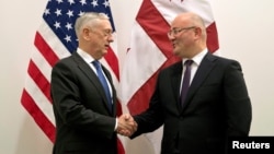 U.S. Secretary of Defense James Mattis, left, greets Georgia's Defense Minister Levan Izoria during a NATO defense ministers meeting at the Alliance headquarters in Brussels, Belgium, Oct. 3, 2018.