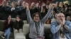 Friends and relatives of Ohad Ben Ami and Eli Sharabi, who were taken from kibbutz Beeri during the Oct. 7, 2023, attack, react as they watch the live broadcast of their release from Hamas captivity in Gaza, at the Kibbutz Beeri, Israel, Feb. 8, 2025.