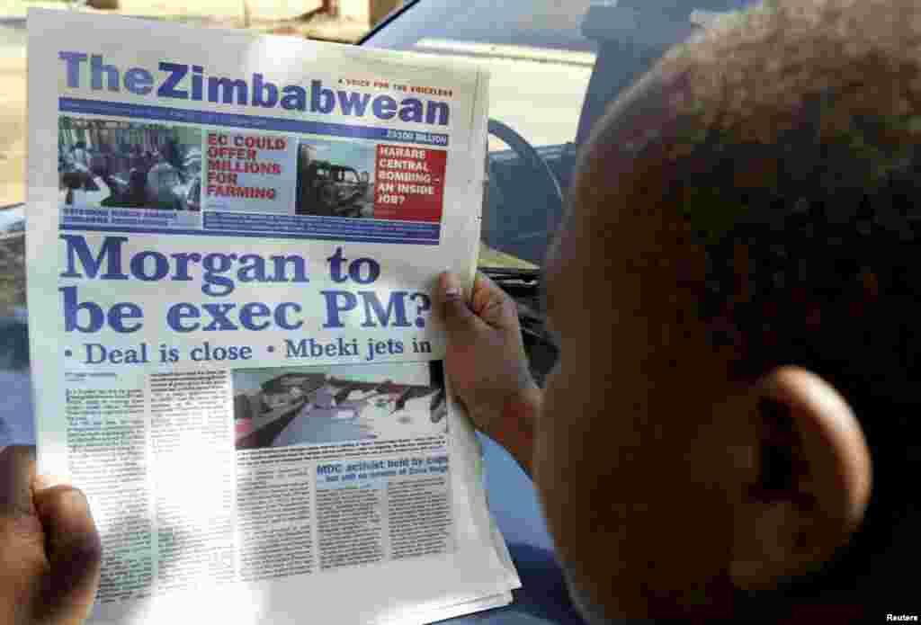 A man reads a local daily newspaper on the street of Zimbabwe's capital Harare August 8, 2008. Zimbabwean President Robert Mugabe and opposition leader Morgan Tsvangirai held make-or-break talks in Harare later that week. 