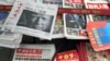FILE - A front page of a Chinese newspaper with a photo of U.S. President-elect Donald Trump and the headline "Outsider counter attack" is displayed at a newsstand in Beijing, China, Nov. 10, 2016. 