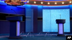 Clear protective panels stand on stage between lecterns for President Donald Trump and Democratic presidential candidate, former Vice President Joe Biden, ahead of their debate at Belmont University, in Nashville, Tennessee, Oct. 21, 2020.