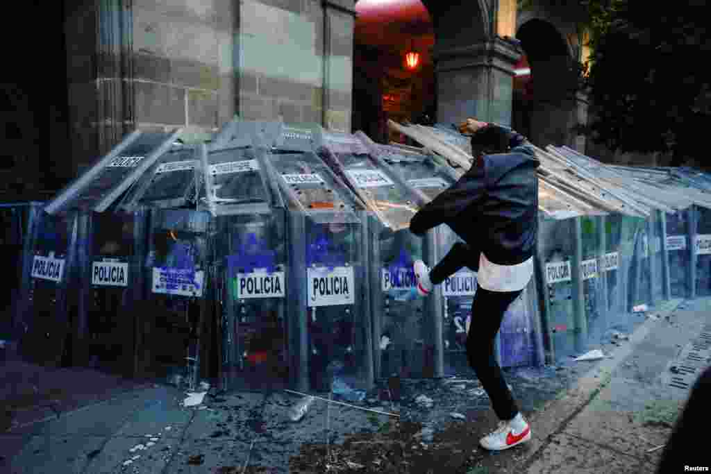 A demonstrator clashes with police officers during a march to mark the 56th anniversary of the 1968 Tlatelolco Square massacre, in which students were shot dead by the military, in Mexico City, Mexico, Oct. 2, 2024.