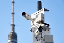 In this photo taken Feb. 22, 2020, two surveillance camera are seen in a street in Moscow.