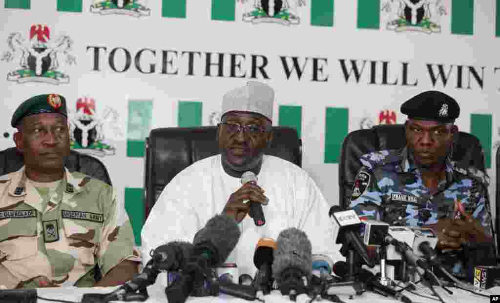 Brig. Gen. Chris Olukolade, Nigeria's top military spokesman (left), Director General, National Orientation Agency, Mike Omeri (center) Frank Mba National police spokesman attend a press conference on the abducted school girls in Abuja, Nigeria, May 12, 2014.