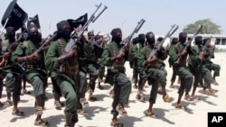 FILE - In this Thursday, Feb. 17, 2011 file photo, hundreds of newly trained al-Shabab fighters perform military exercises in the Lafofe area some 18 km south of Mogadishu, in Somalia.