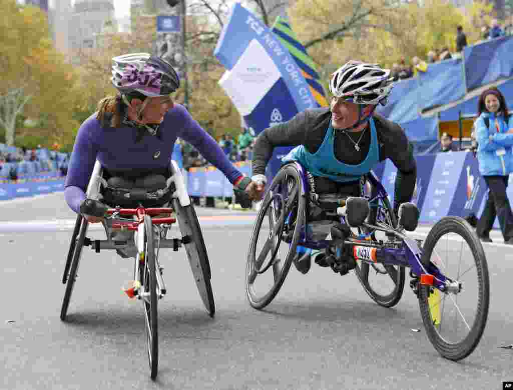 Runner-up Manuela Schar, left, of Switzerland, congratulates winner Tatyana McFadden of the United States after the pair competed in the women's wheelchair division of the 44th annual New York City Marathon in New York, Nov. 2, 2014.