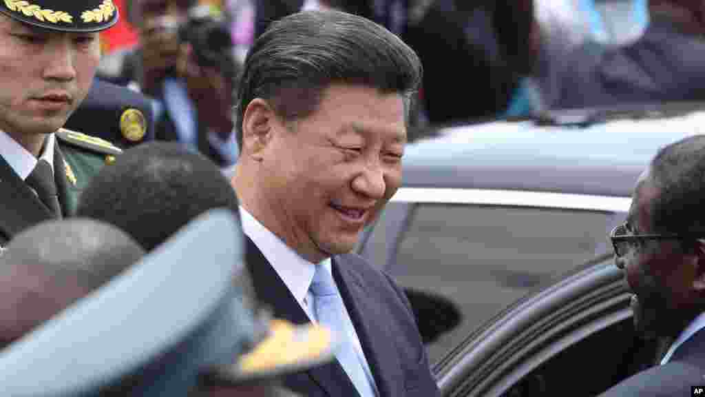 Chinese President Xi Jinping, chats to Zimbabwean President Robert Mugabe, right, upon his arrival in Harare, Zimbabwe, Tuesday, Dec. 1. 2015. Jinping is in Zimbabwe for a two day State visit during which he is set to sign some bilateral agreements aimed at strengthening relationships between the two countries.