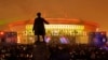 FILE - People watch a light show at the new soccer stadium on Krestovsky Island, which will host some 2018 World Cup and 2017 Confederations Cup matches, in St. Petersburg, Russia, April 22, 2017.