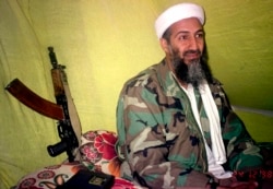 FILE - Then-al-Qaida leader Osama Bin Laden speaks to a select group of reporters in mountains of Helmand province in southern Afghanistan, Dec. 24, 1998.