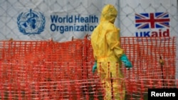FILE PHOTO: A person dressed in Ebola protective apparel is seen inside an Ebola care facility at the Bwera general hospital near the border with the Democratic Republic of Congo in Bwera, Uganda, June 14, 2019. REUTERS/James Akena/File Photo