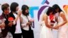Newly married same-sex couple Tran Ngoc Diem Hang (R) and Le Thuy Linh (2nd R) during their public wedding as part of a lesbian, gay, bisexual, and transgender (LGBT) event on a street in Hanoi Oct. 27, 2013.