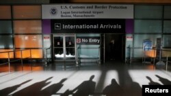 FILE - An international traveler arrives after U.S. President Donald Trump's executive order travel ban at Logan Airport in Boston, Massachusetts.