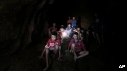 This Monday, July 2, 2018, photo released by Tham Luang Rescue Operation Center, shows the boys and their soccer coach as they were found in a partially flooded cave, in Mae Sai, Chiang Rai, Thailand.