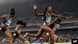 Brianna Rollins from the United States celebrates after winning the gold medal in the women's 100-meter hurdles final during the athletics competitions of the 2016 Summer Olympics at the Olympic stadium in Rio de Janeiro, Brazil, Wednesday, Aug. 17, 2016.