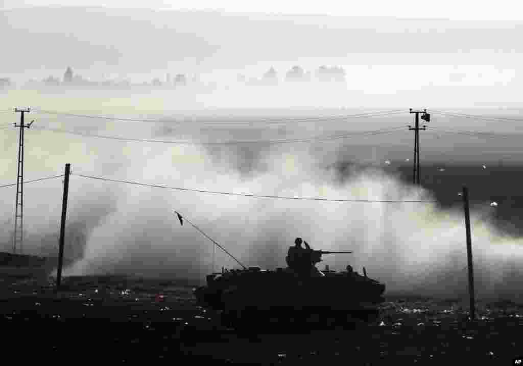 A Turkish armored vehicle patrols the border where fighting between Syrian Kurds and the Islamic State militants has intensified, on the Turkey-Syria border, Oct. 10, 2014.