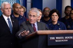 Dr. Anthony Fauci, director of the National Institute of Allergy and Infectious Diseases, with Vice President Mike Pence behind him, speaks during a briefing about the coronavirus at the White House, March 15, 2020.