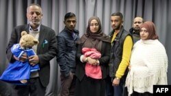 The families of missing British girls Amira Abase and Shamima Begum pose for a picture after being interviewed by the media in central London, Feb. 22, 2015. 
