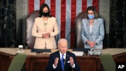 President Joe Biden addresses a joint session of Congress, Wednesday, April 28, 2021, in the House Chamber at the U.S. Capitol in Washington, as Vice President Kamala Harris, left, and House Speaker Nancy Pelosi of Calif., look on. (Chip Somodevilla/Pool via AP)