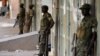 FILE - Ugandan soldiers stand along a street in Kampala, Uganda, Feb. 20, 2016. Ugandan President Yoweri Museveni extended his 30-year rule earlier this year by winning an election critics say lacked transparency and his main opponent Kizza Besiyge denoun