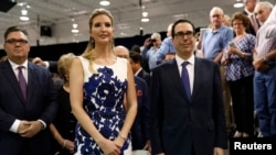 FILE - White House Senior Adviser Ivanka Trump and Treasury Secretary Steven Mnuchin (R) stand by prior to U.S. President Donald Trump's speech on tax reform at Loren Cook Company in Springfield, Missouri, Aug. 30, 2017.