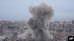 Smoke rises between buildings hit in a Israeli airstrike in Dahiyeh, in the southern suburb of Beirut, Lebanon, Nov. 17, 2024. 