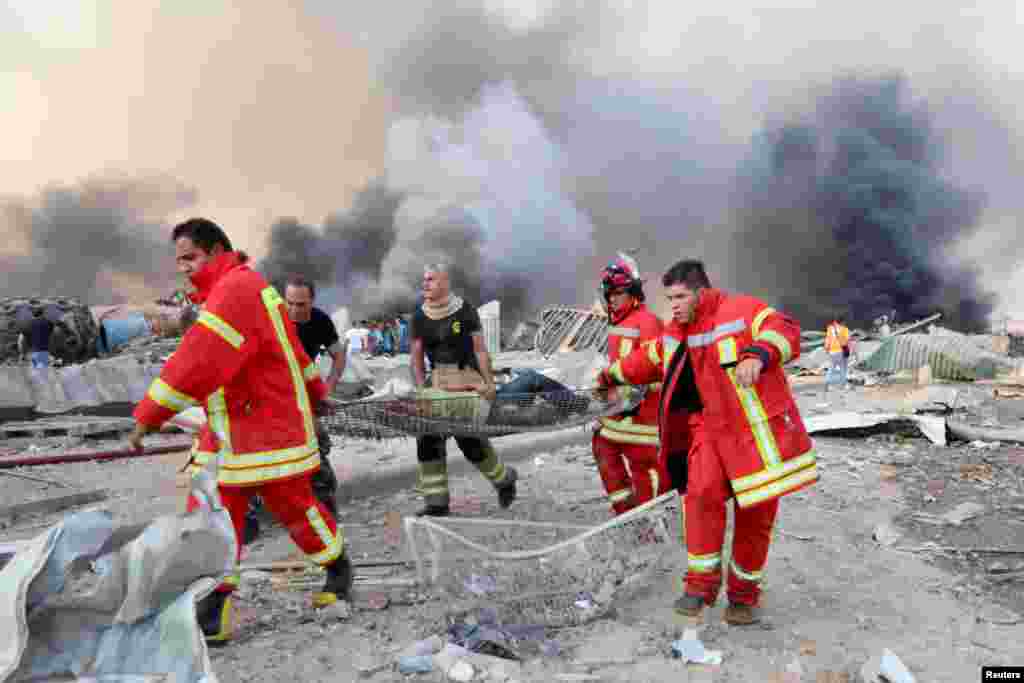 A man is evacuated at the site of an explosion in Beirut, Lebanon, Aug. 4, 2020.