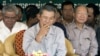 Cambodia's Prime Minister Hun Sen, center, smokes as he sits with Interior Minister Sar Kheng, left, and Finance Minister Keat Chhun, right, during the inauguration of the China-funded construction of a bridge in Mouk Kampoul district, Kandal province, some 20 kilometers (12 miles) north of Phnom Pen, Cambodia, file photo. 