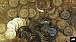 FILE - Bitcoin tokens 