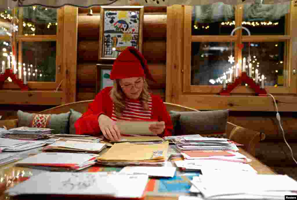 Elina, dressed as a Christmas elf, reads letters from around the world at the Santa Claus' Post Office.