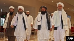 FILE - Taliban officials walk down a hotel lobby during talks in Doha, Qatar, Aug. 12, 2021. UN Secretary-General António Guterres will convene a meeting of various countries’ special representatives for Afghanistan in Qatar on February 18, 2024. 