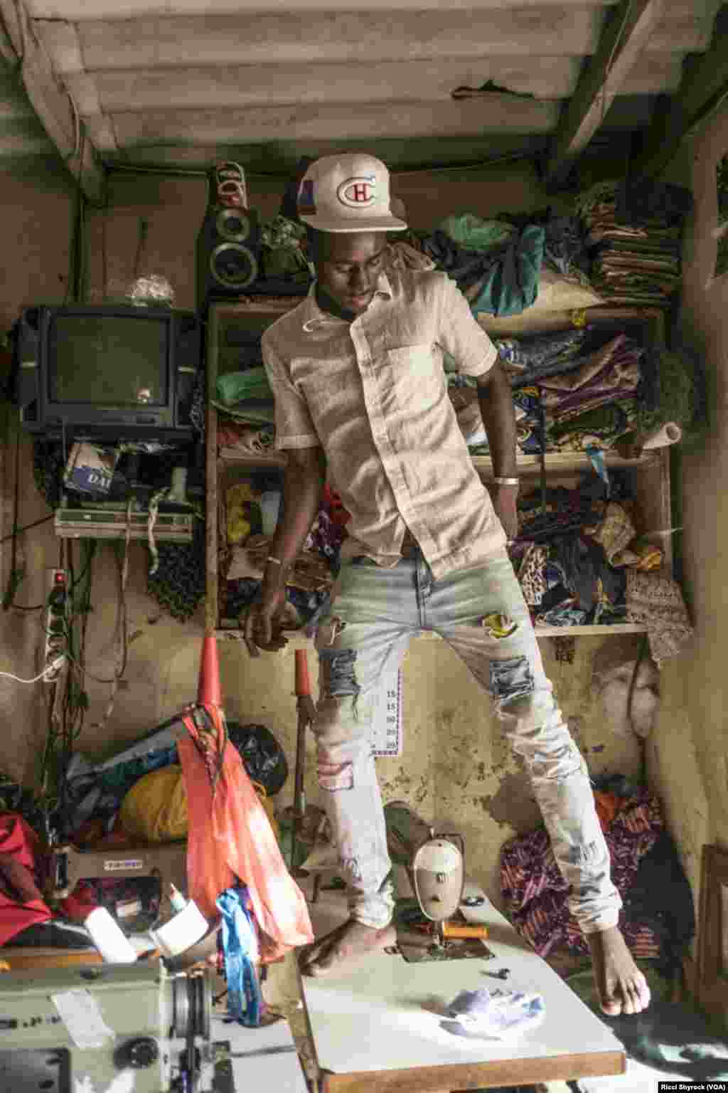 A tailor works in Dakar's Niary Tally neighborhood, the working class area where Dakar Fashion Week held their "Street Parade" fashion show this year, June 29, 2017. The show is free and takes place in an open and public area each year as part of Dakar Fashion Week's events.