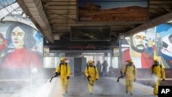 Employees of the Federal State Center for Special Risk Rescue Operations of Russia Emergency Situations disinfect a platform of Leningradsky railway station in Moscow, Russia, May 19, 2020.