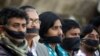 FILE - Activists of the leftist alliance cover their mouths with black cloths as they join in a rally to demand a new election under caretaker government, in Dhaka, Bangladesh, Jan. 3, 2019.
