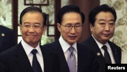 China's Premier Wen Jiabao (L), South Korea's President Lee Myung-bak (C) and Japan's Prime Minister Yoshihiko Noda arrive at a joint news conference of the fifth trilateral summit among the three nations at the Great Hall of the People in Beijing, May 13