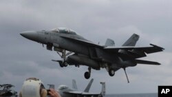 FILE - A U.S. Navy's F/A-18 Super Hornet fighter approaches the deck of the Nimitz-class aircraft carrier USS Carl Vinson during the annual joint military exercise between South Korea and the United States, March 14, 2017.