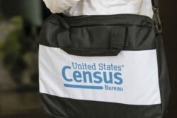 FILE - A briefcase of a census taker is seen as she knocks on the door of a residence Aug. 11, 2020, in Winter Park, Fla.