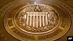 FILE - the seal of the Board of Governors of the United States Federal Reserve System in the ground at the Marriner S. Eccles Federal Reserve Board Building in Washington. 